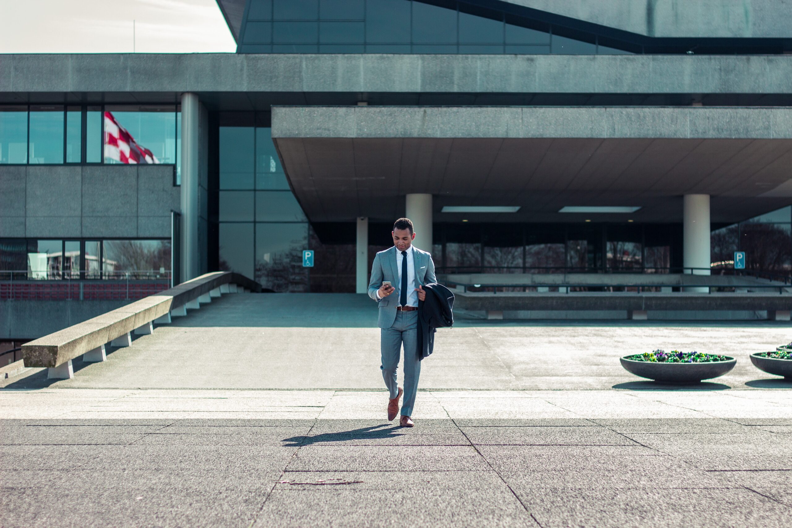 man walking out of a business on the phone with a virtual answering service