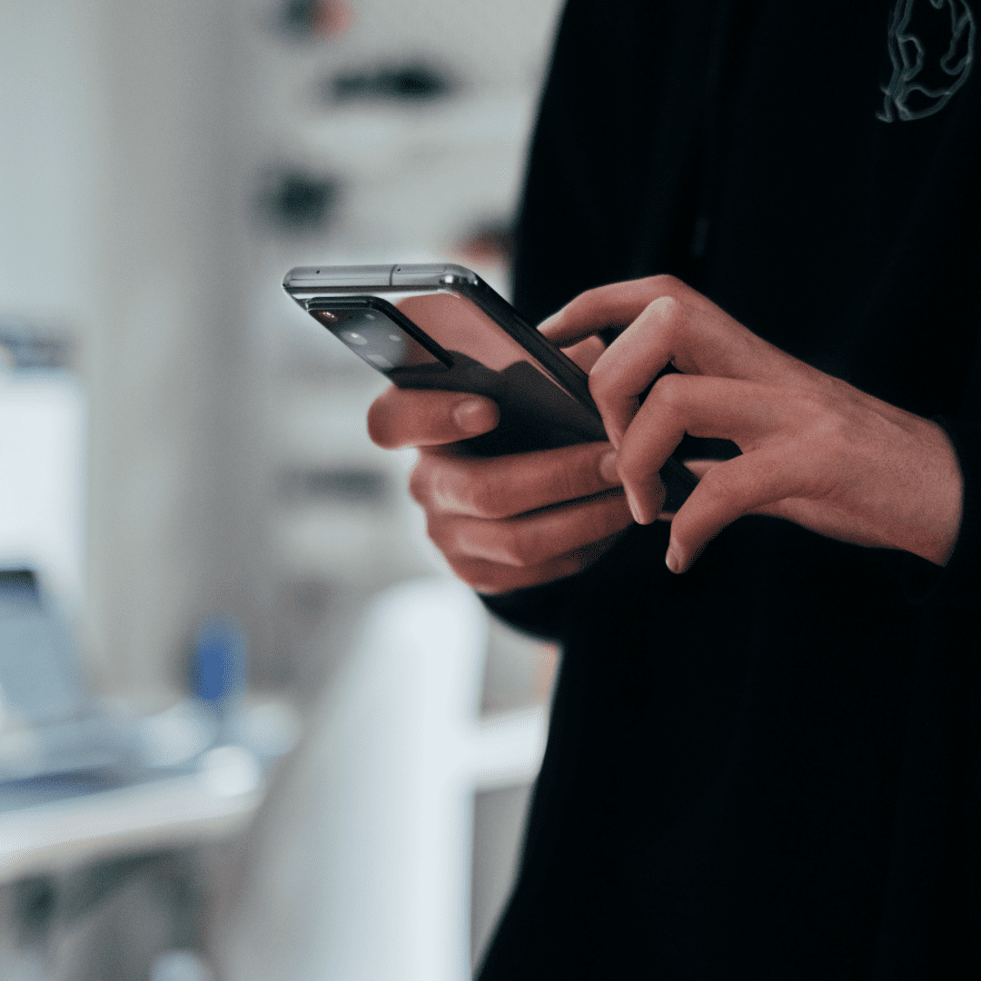 person on their phone with Event Registration Systems