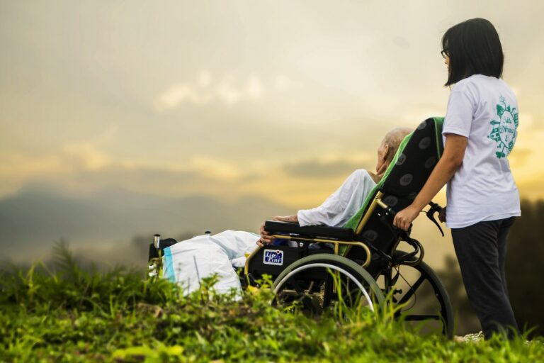 image of a hospice worker pushing a woman in a wheelchair outside, indicating the better patient relationships that can happen when you hire a medical office answering service
