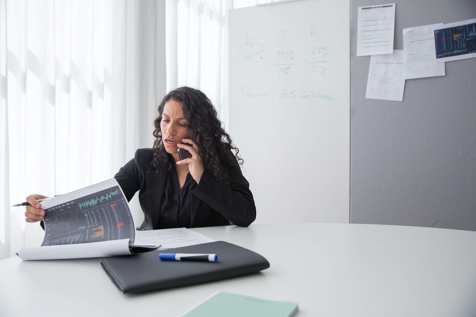 a woman on the phone looking at the best Customer service survey questions on her laptop